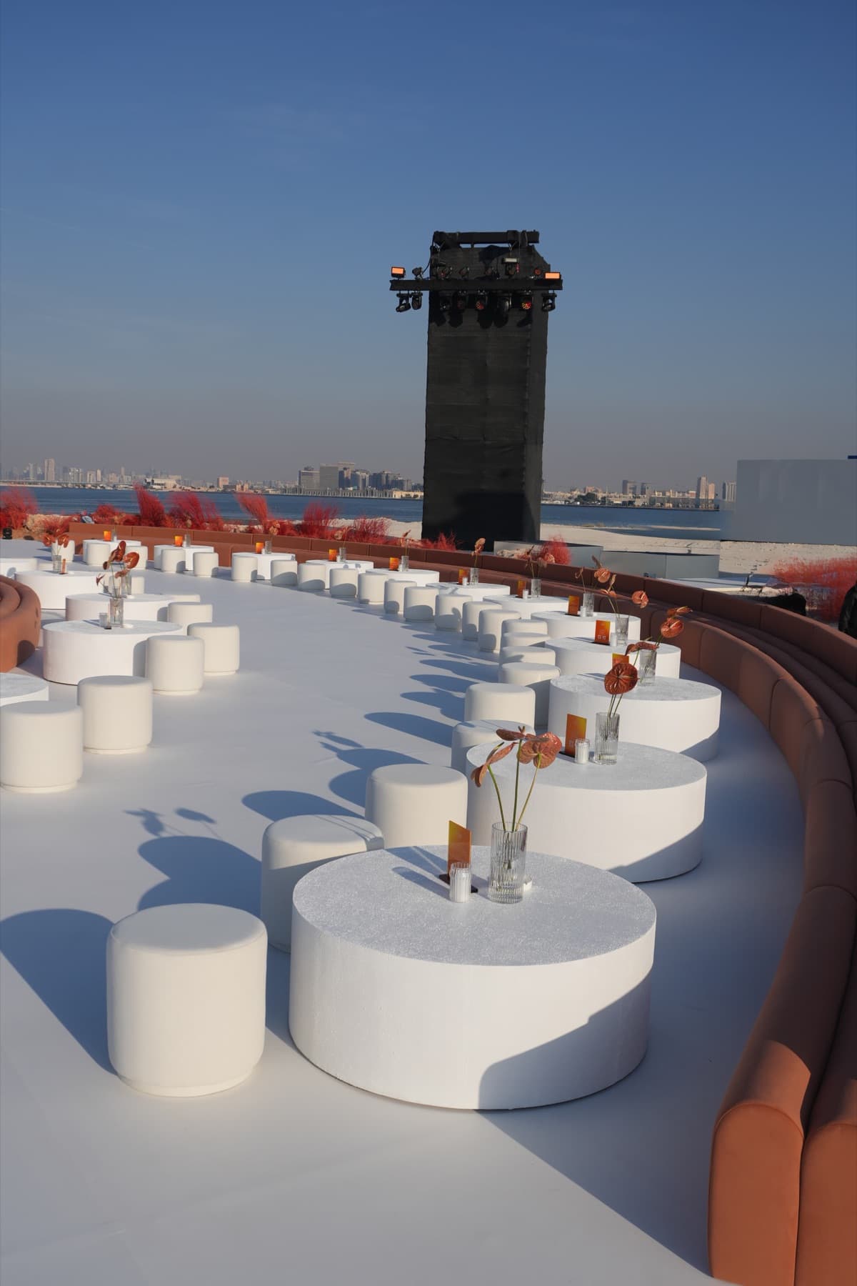 A waterfront majlis set at dusk