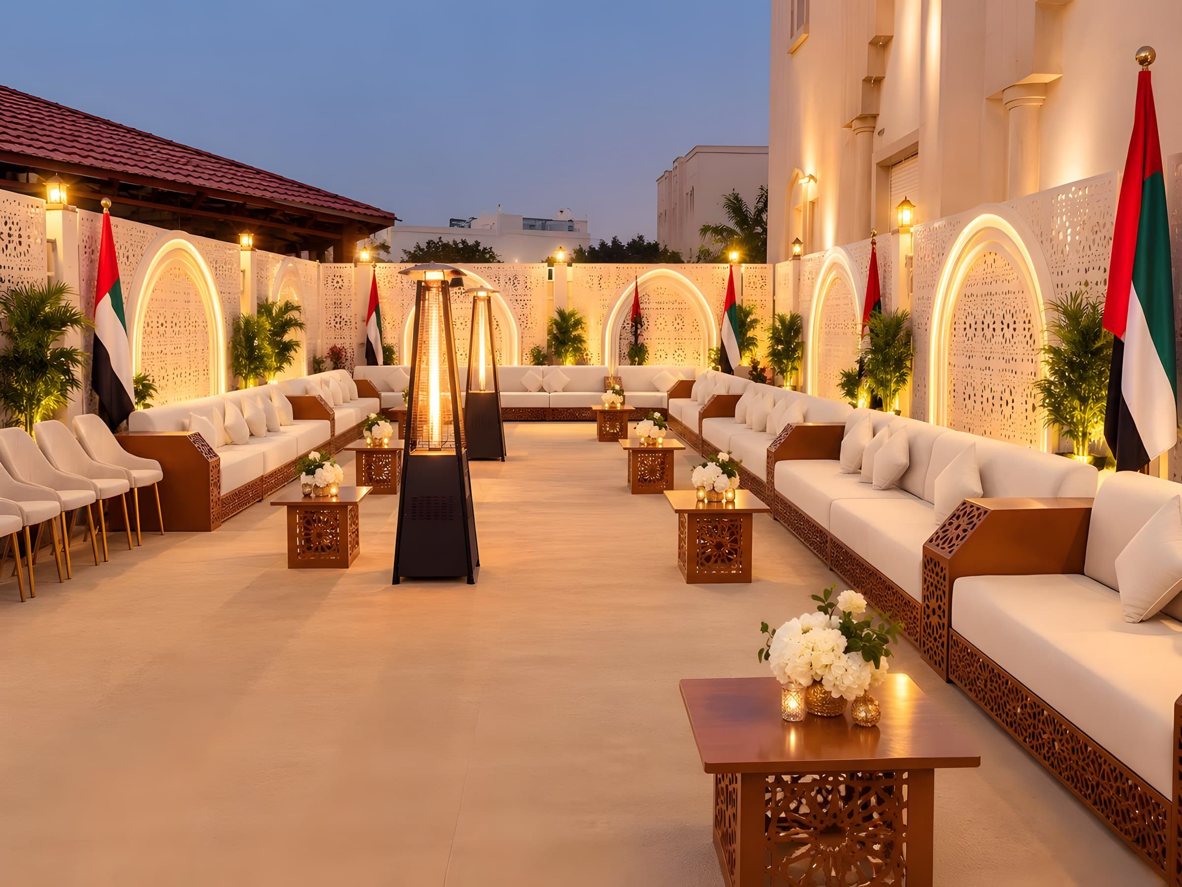 Curved terracotta benches and white tables by the sea