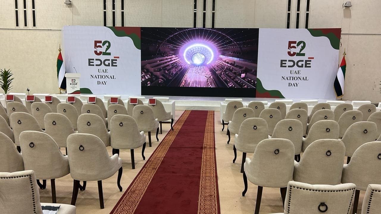 A stage with LED screen and flags