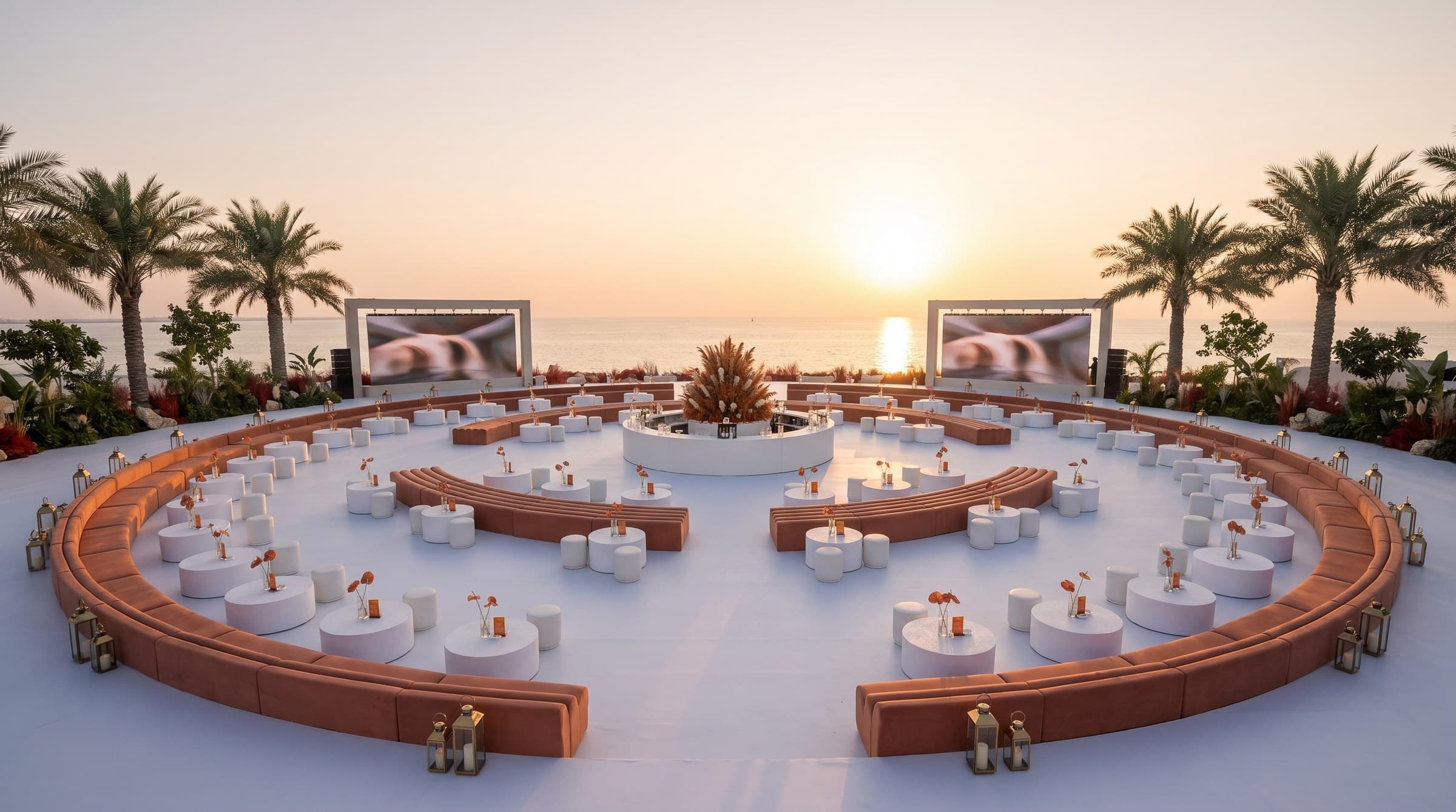 A seaside reception at golden hour, from above